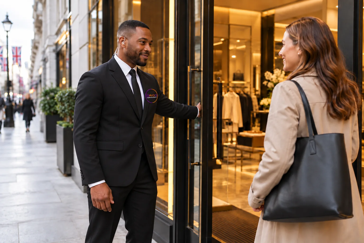 Illustrative security officer in a black suit and white shirt assisting a retail customer